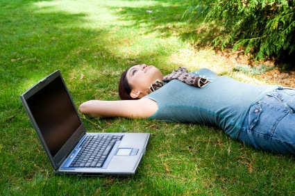 A college student taking a break and relaxing at a park